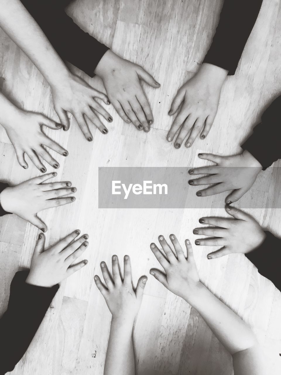 Cropped image of hands on hardwood floor