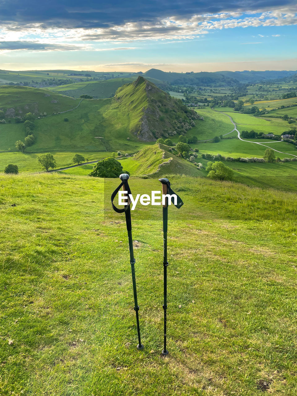 Hiking poles in front of dragons back hills in the peak district from the summit 