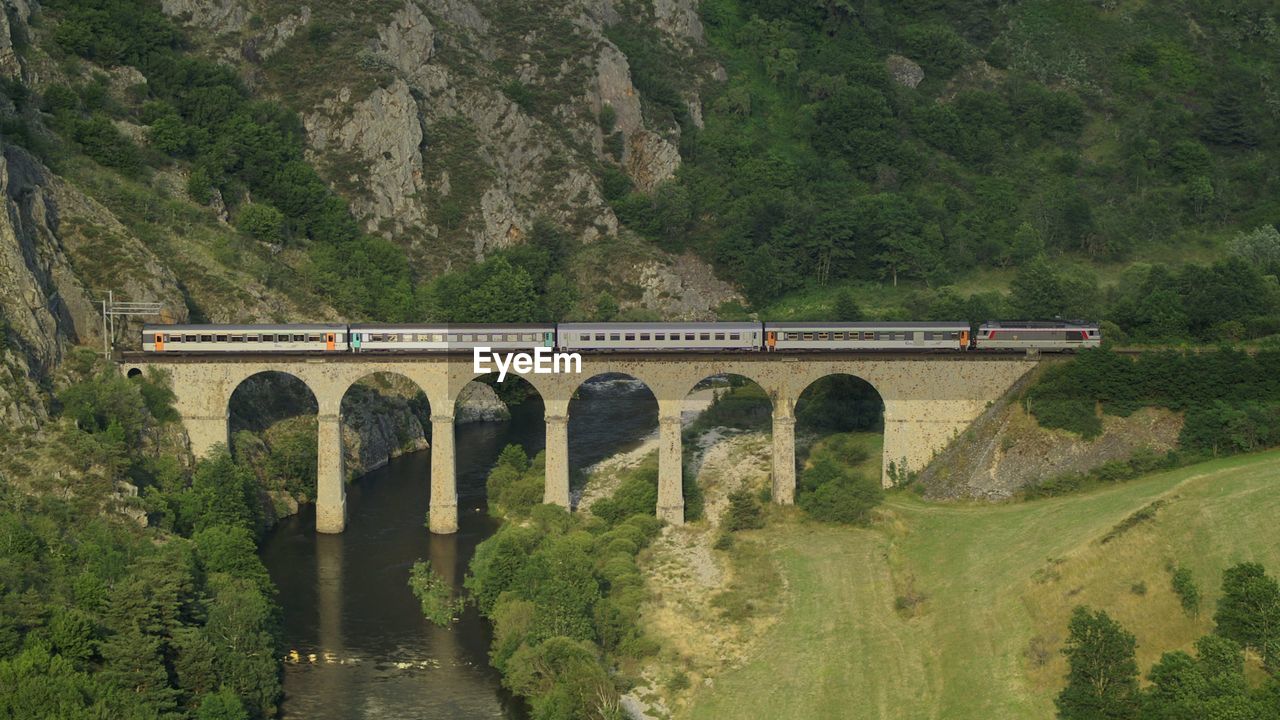 Train on railway bridge over river
