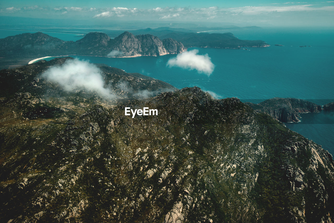 HIGH ANGLE VIEW OF SEA AND MOUNTAIN