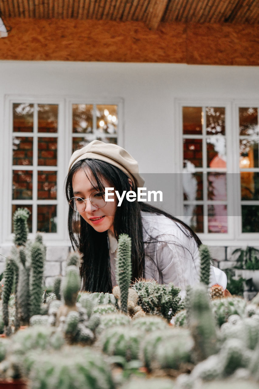 Smiling woman looking at cactus