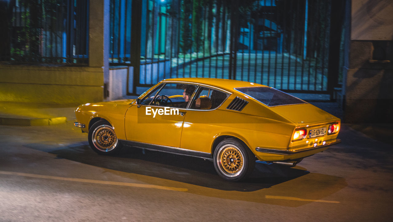 YELLOW CAR ON ROAD