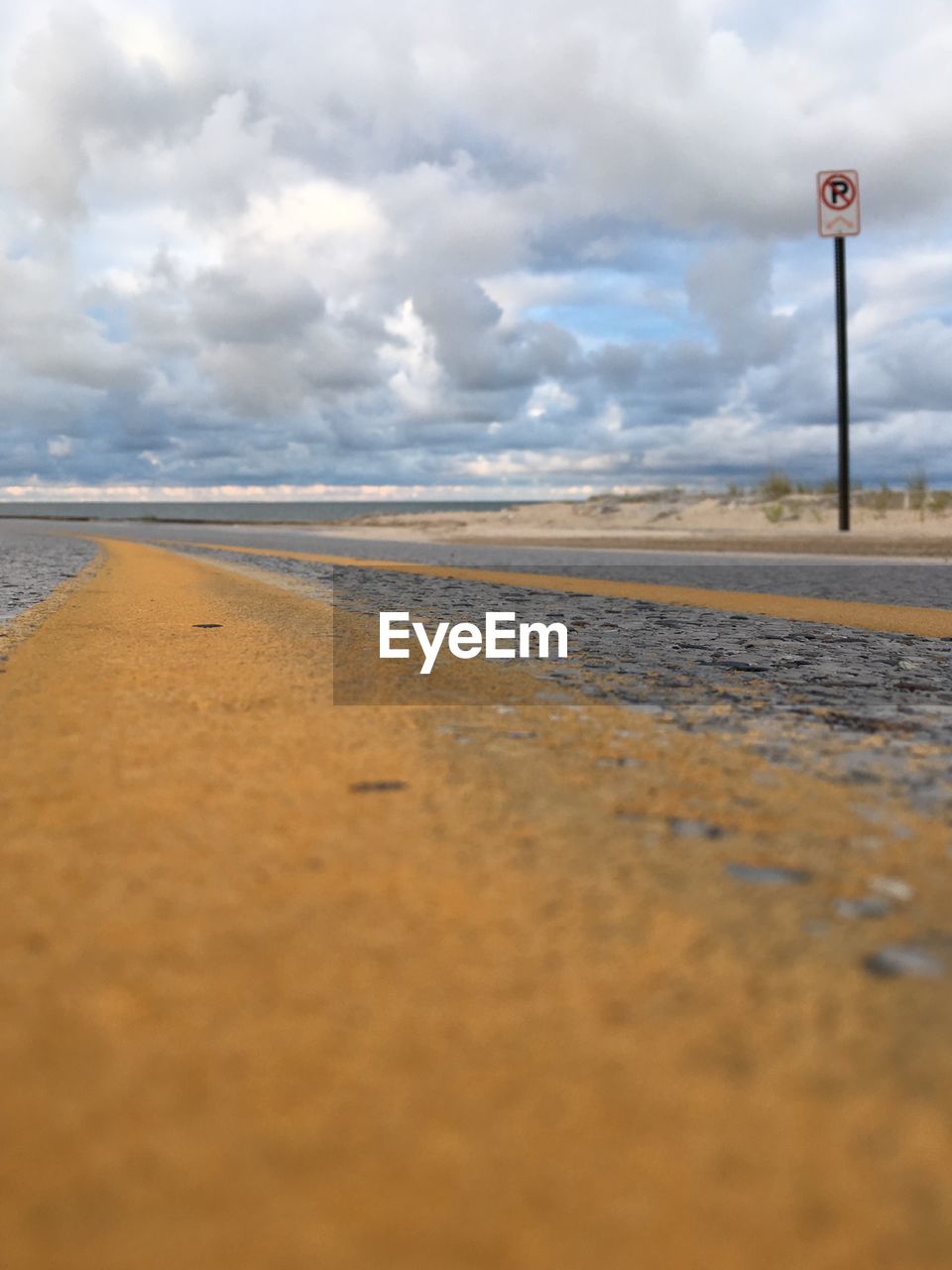 VIEW OF ROAD BY SEA AGAINST SKY