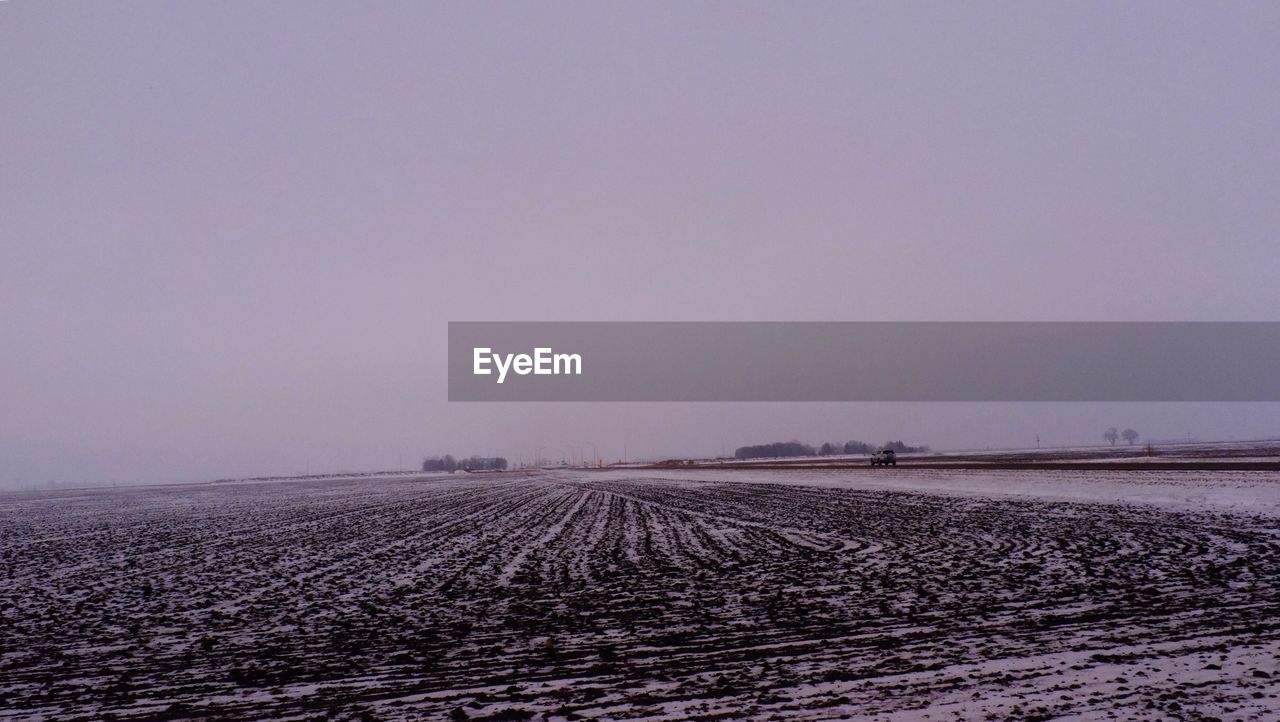 Distance shot of vehicle on snow covered landscape