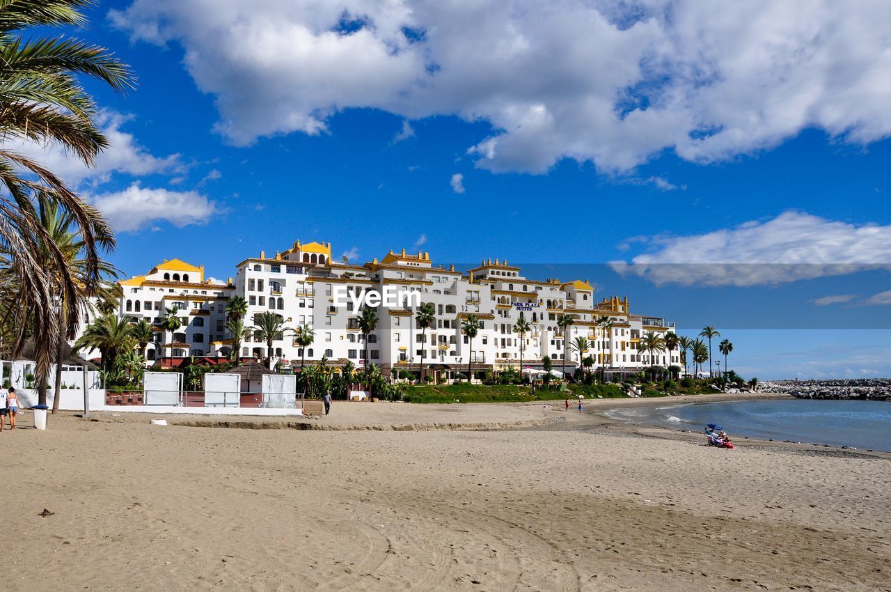 View of buildings against blue sky and clouds