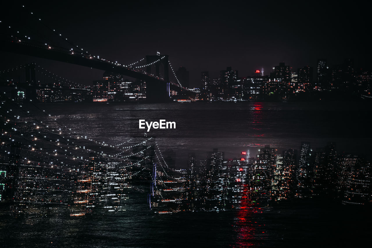 Double exposure of manhattan skyline, brooklyn bridge from dumbo park in new york city, usa