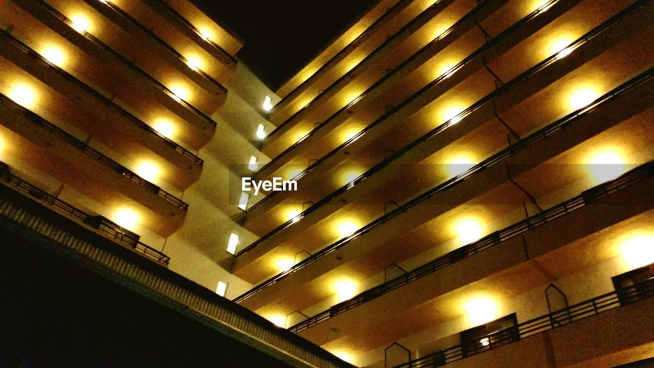 LOW ANGLE VIEW OF ILLUMINATED LIGHTS AT NIGHT