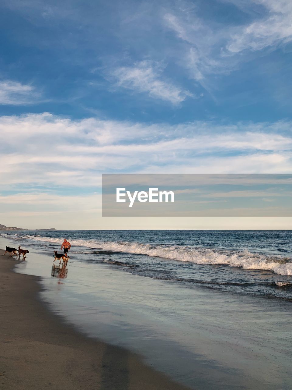 PEOPLE AT BEACH AGAINST SKY