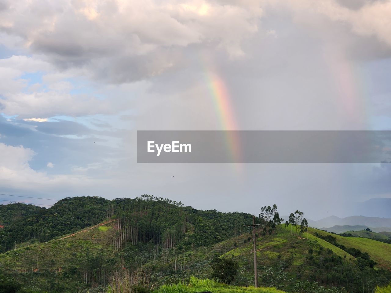 rainbow, cloud, environment, sky, beauty in nature, scenics - nature, landscape, multi colored, nature, land, mountain, plant, tranquility, tree, idyllic, tranquil scene, natural phenomenon, field, no people, spectrum, non-urban scene, rain, rural scene, double rainbow, wet, dramatic sky, outdoors, forest, green, travel, travel destinations, tourism, day, grass, hill station, storm, sunlight, summer, water, highland, overcast, atmospheric mood, valley, social issues, environmental conservation