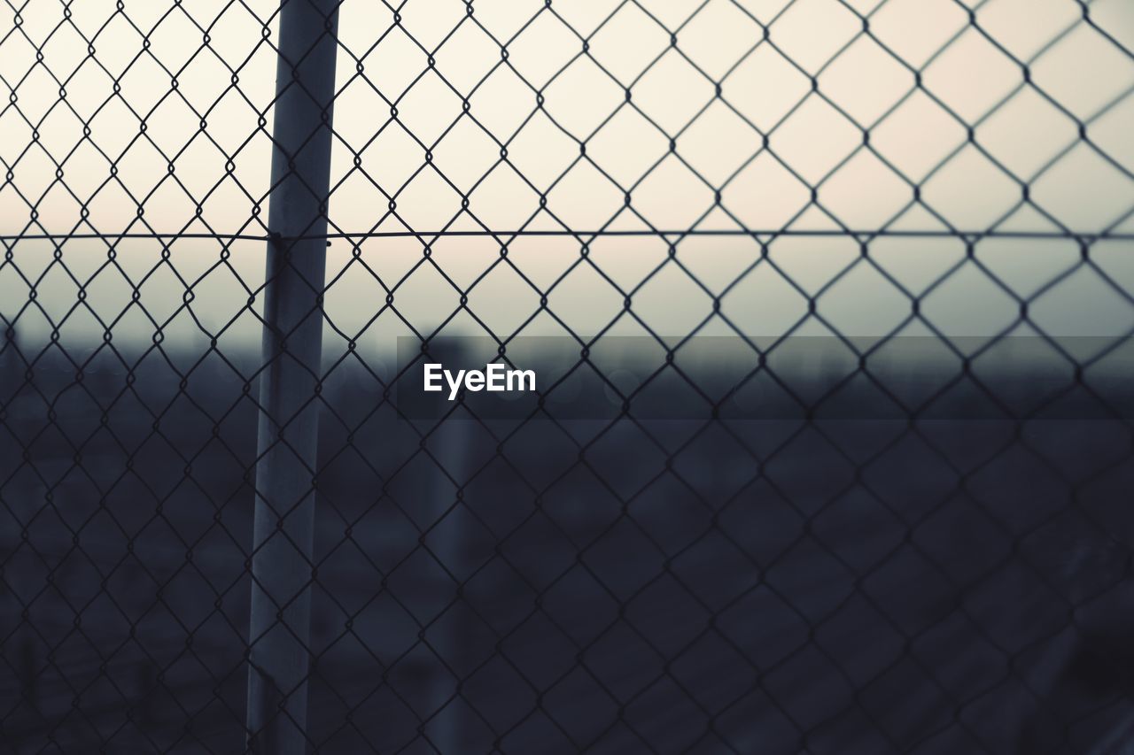 Full frame shot of chainlink fence against sky