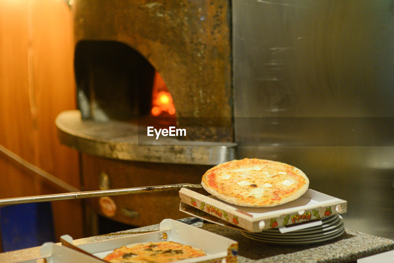 Cooking pizza in the wood copper oven