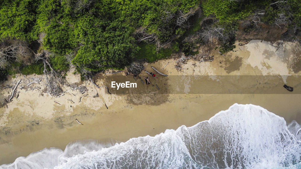 Aerial view of man lying on beach