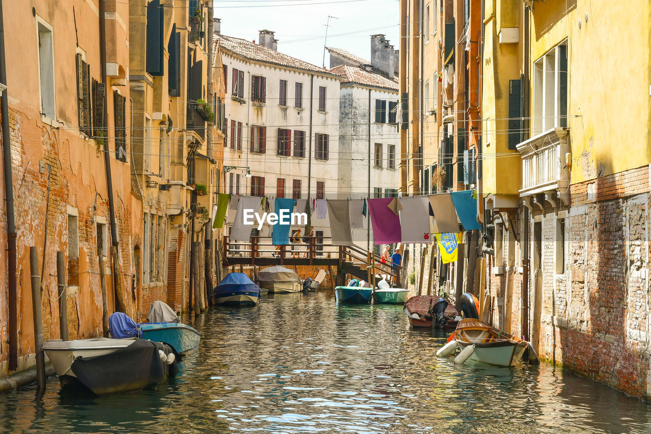Picturesque venetian canal with cloths hanging between the houses to dry, venice, italy
