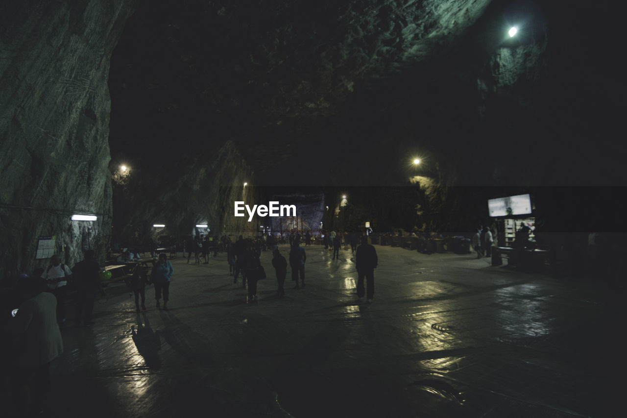 PEOPLE WALKING ON ROAD AT NIGHT