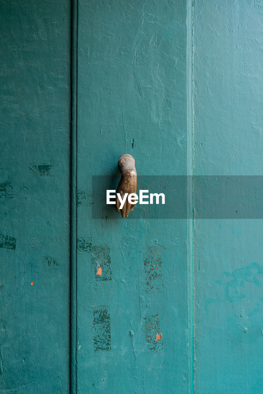 FULL FRAME SHOT OF BLUE DOOR ON WALL