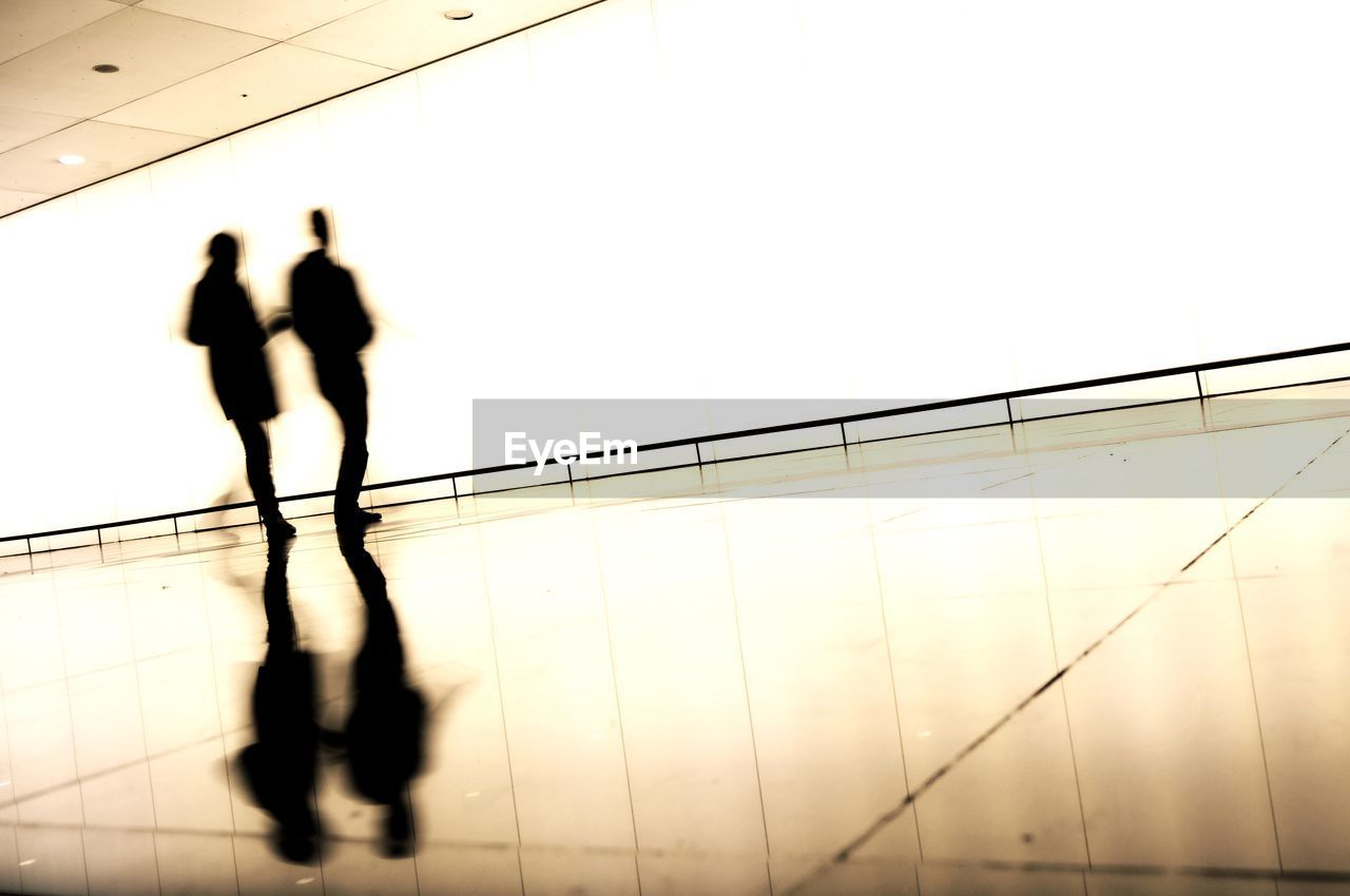 Low angle view of silhouette man walking against clear sky