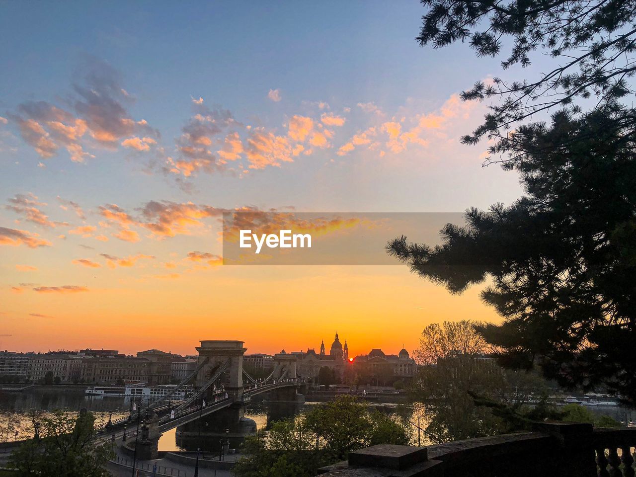 City view against cloudy sky during sunrise