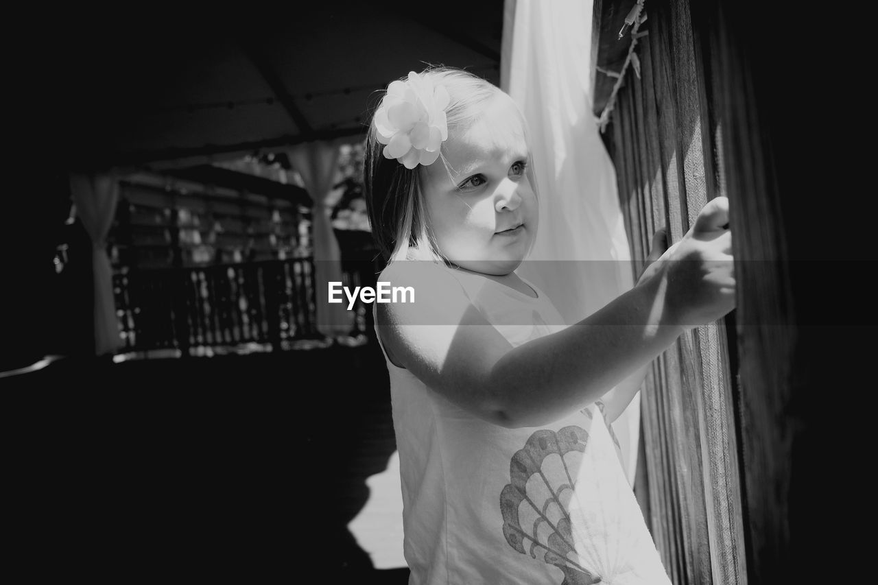 Close-up of girl standing by railing