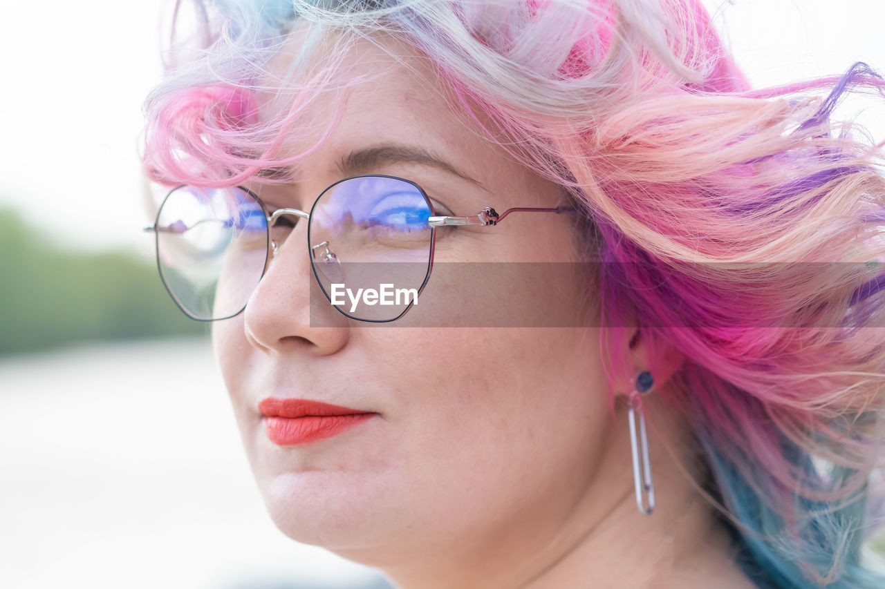 Portrait of woman wearing eyeglasses outdoors