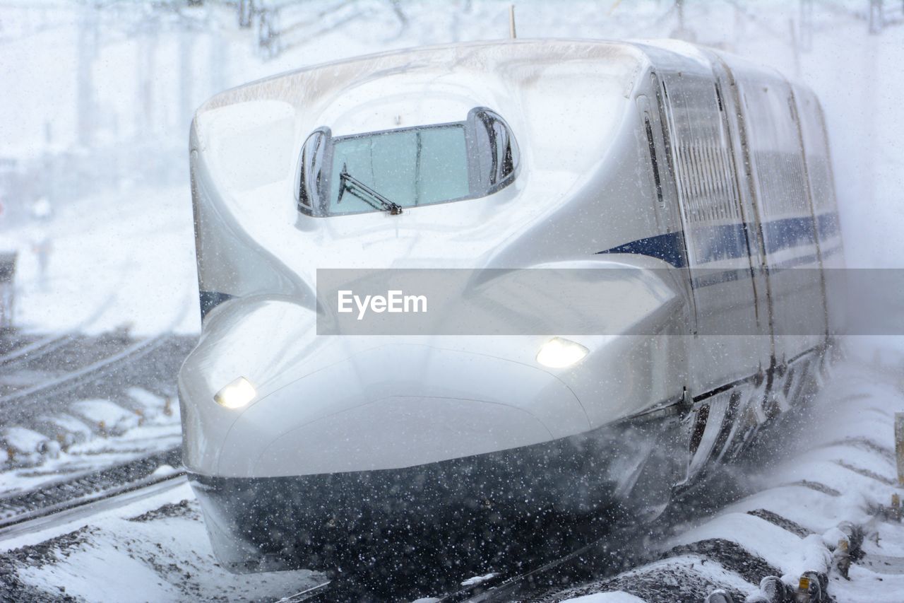 snow, winter, cold temperature, mode of transportation, transportation, vehicle, train, car, motor vehicle, snowing, bullet train, nature, freezing, frozen, blizzard, ice, white, winter storm, transport, travel, day, outdoors, land vehicle, no people, high-speed rail, automobile, maglev
