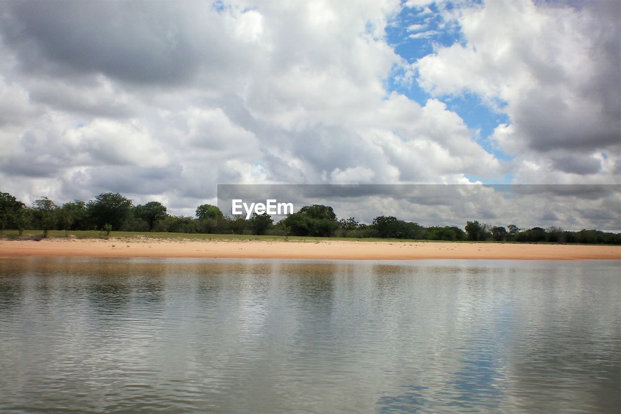 Scenic view of lake against cloudy sky