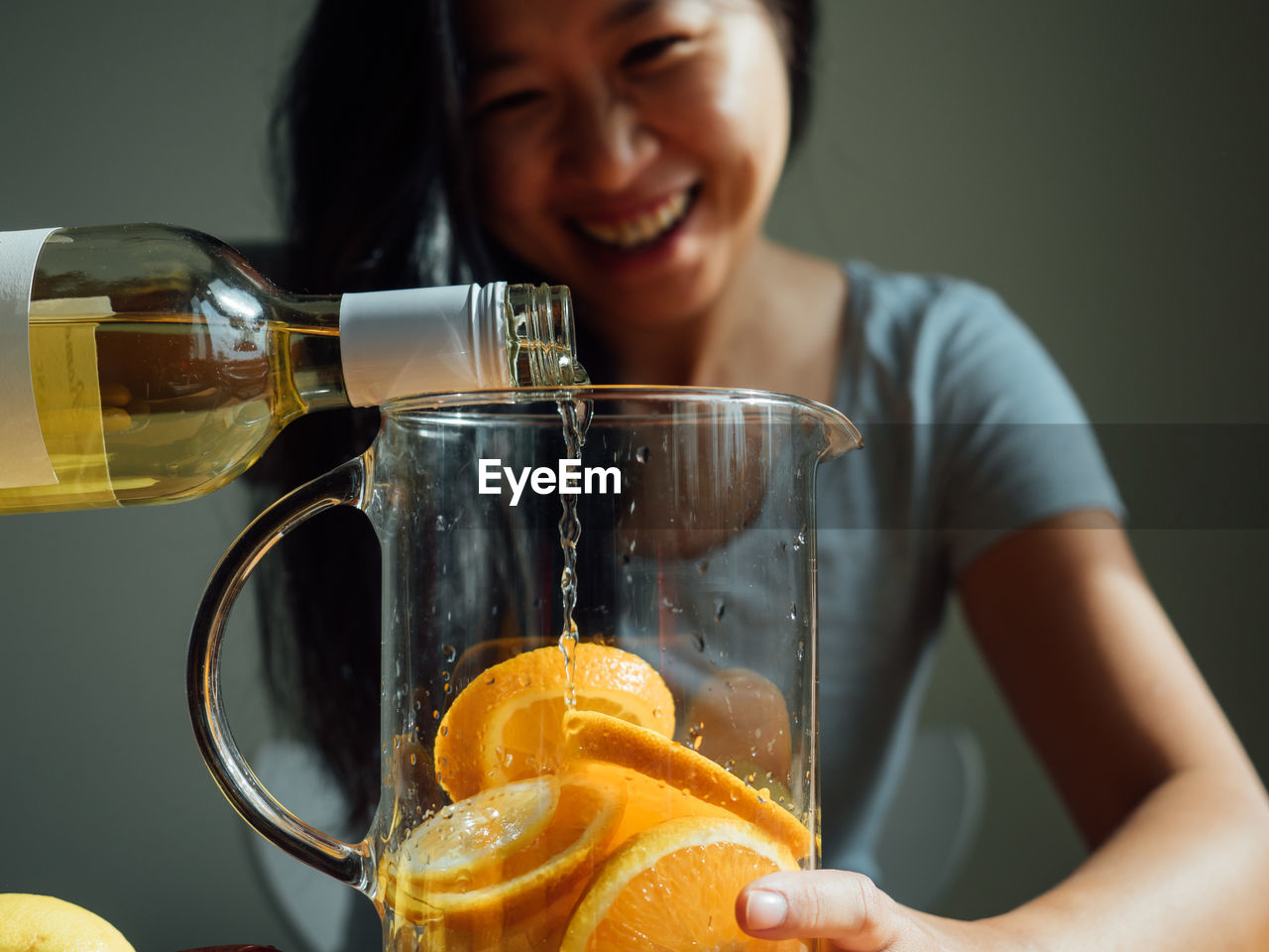 Smiling woman preparing drink