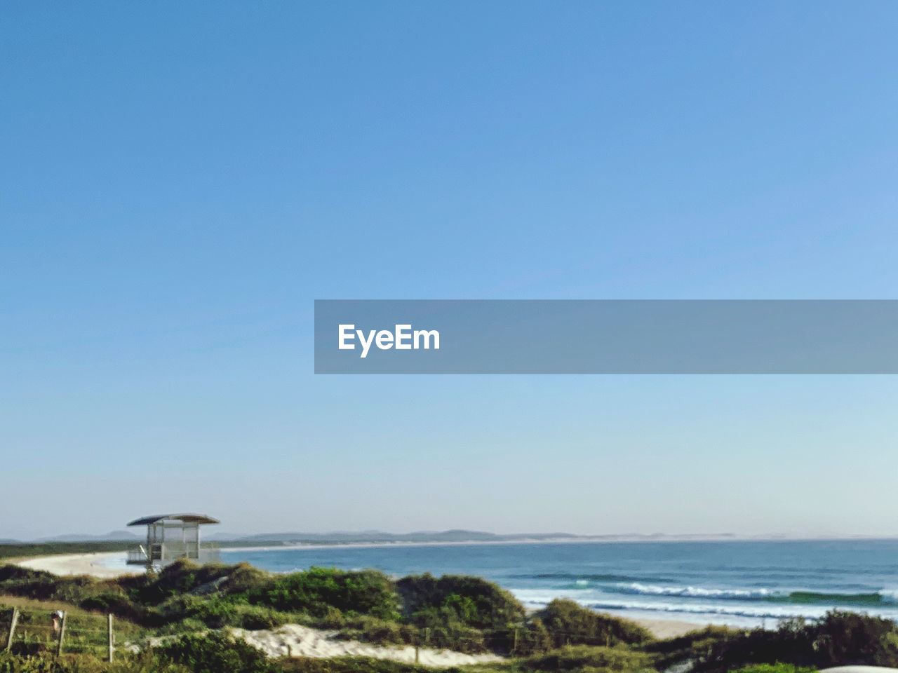 SCENIC VIEW OF BEACH AGAINST CLEAR SKY