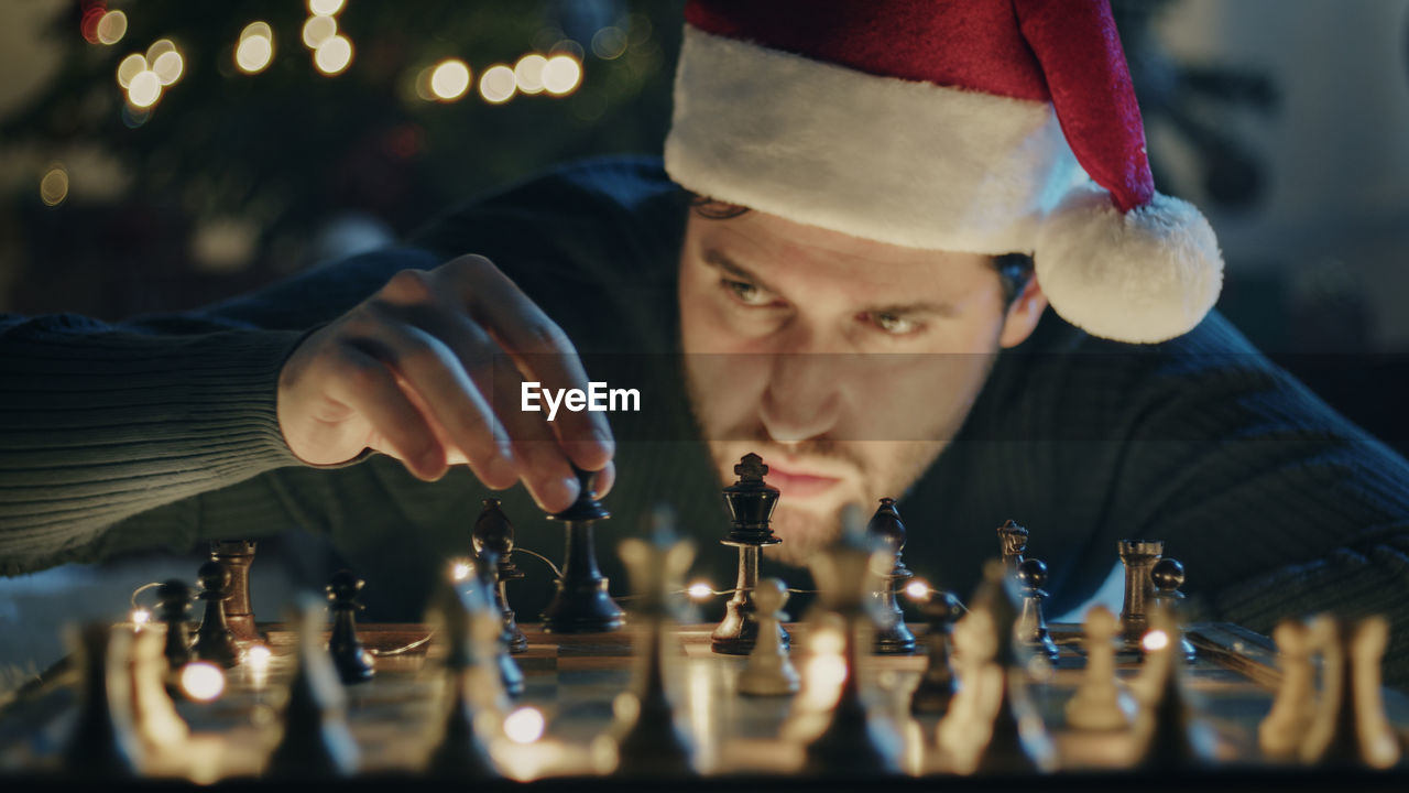 Boy plays chess on christmas mood