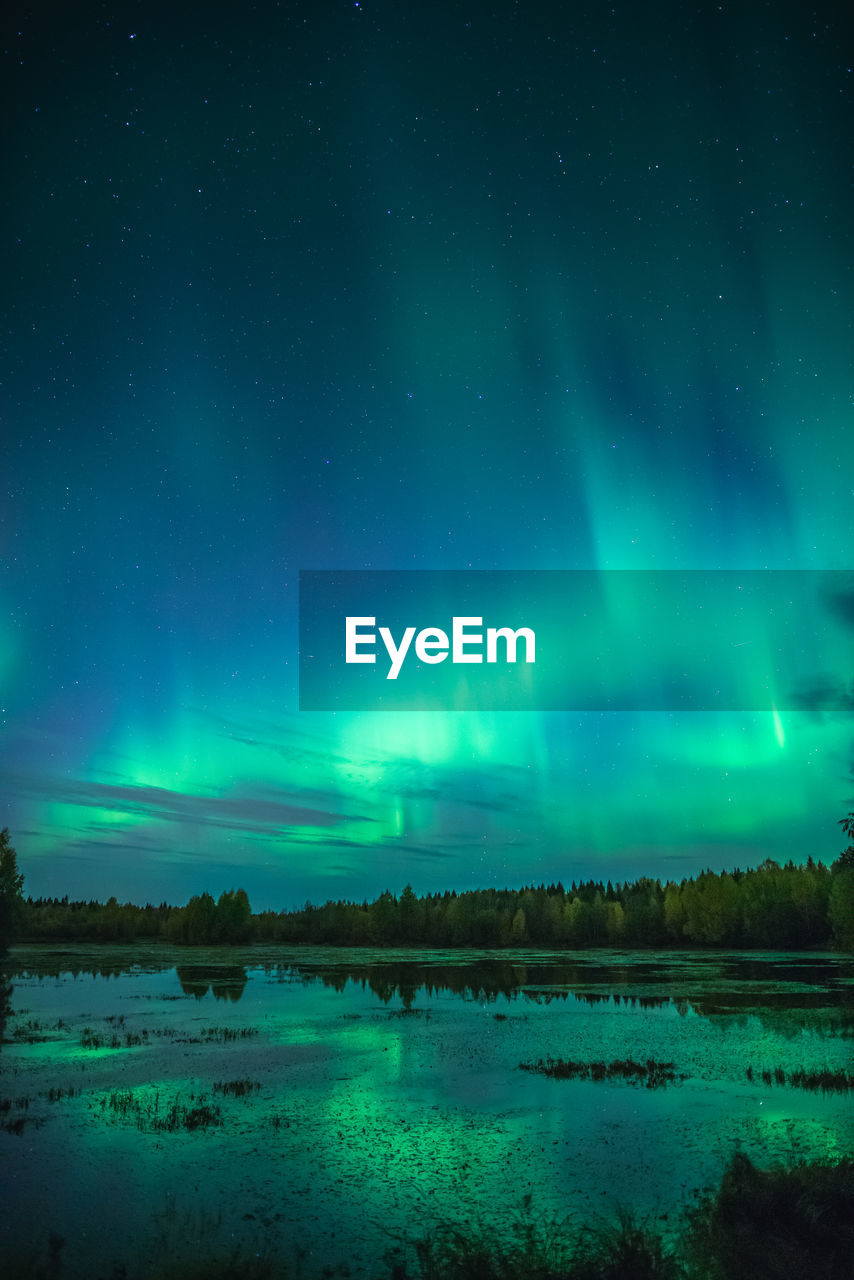 Scenic view of lake against sky at night