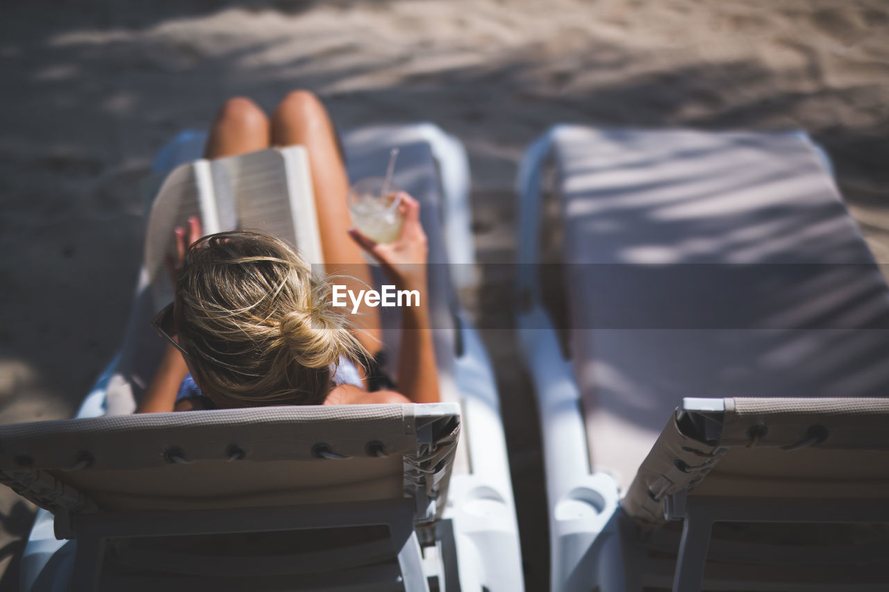 Woman sitting on lounge chair