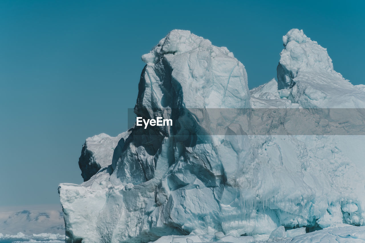 low angle view of snow covered mountain against sky