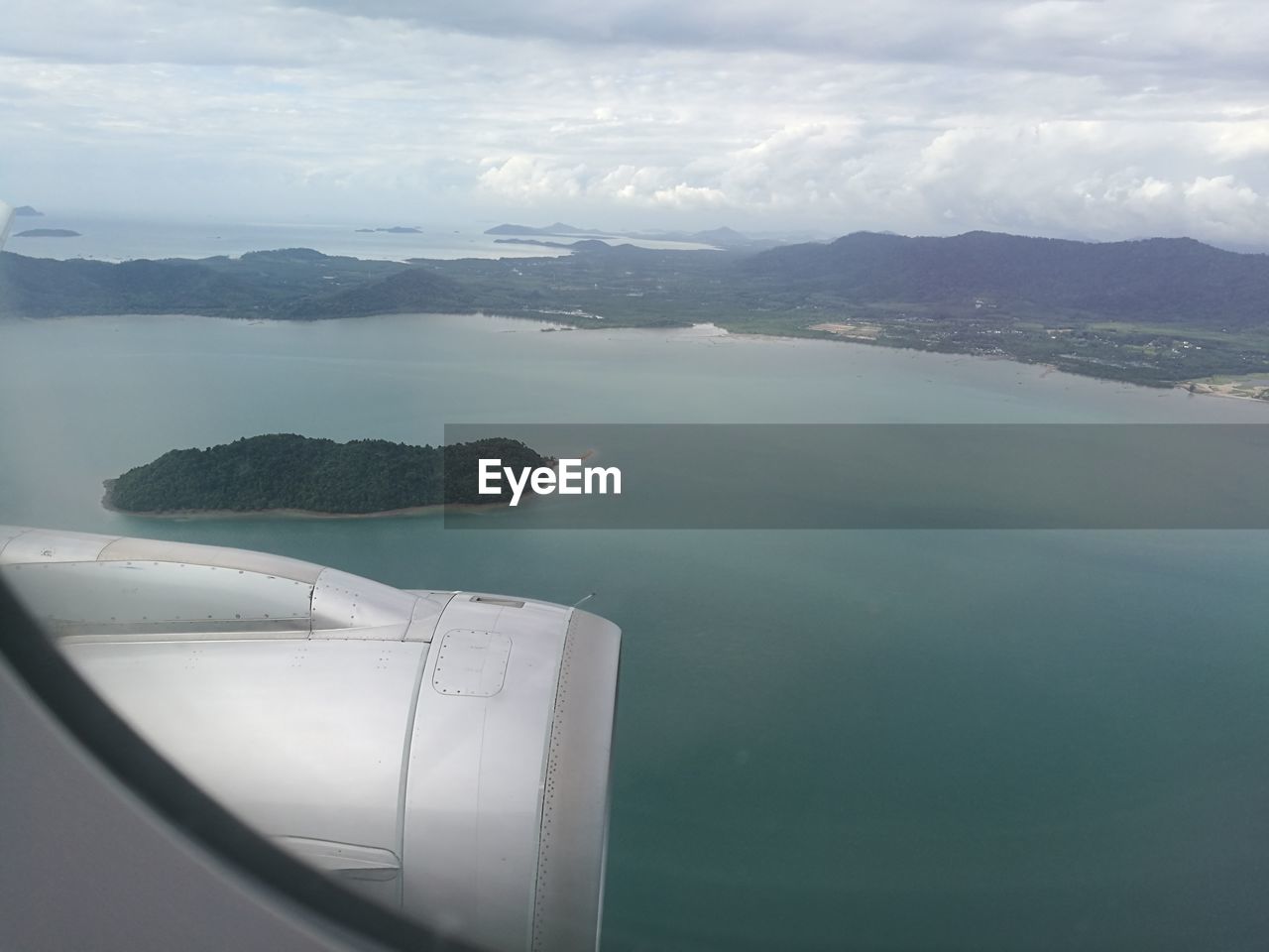 CLOSE-UP OF AIRPLANE WING OVER SEA