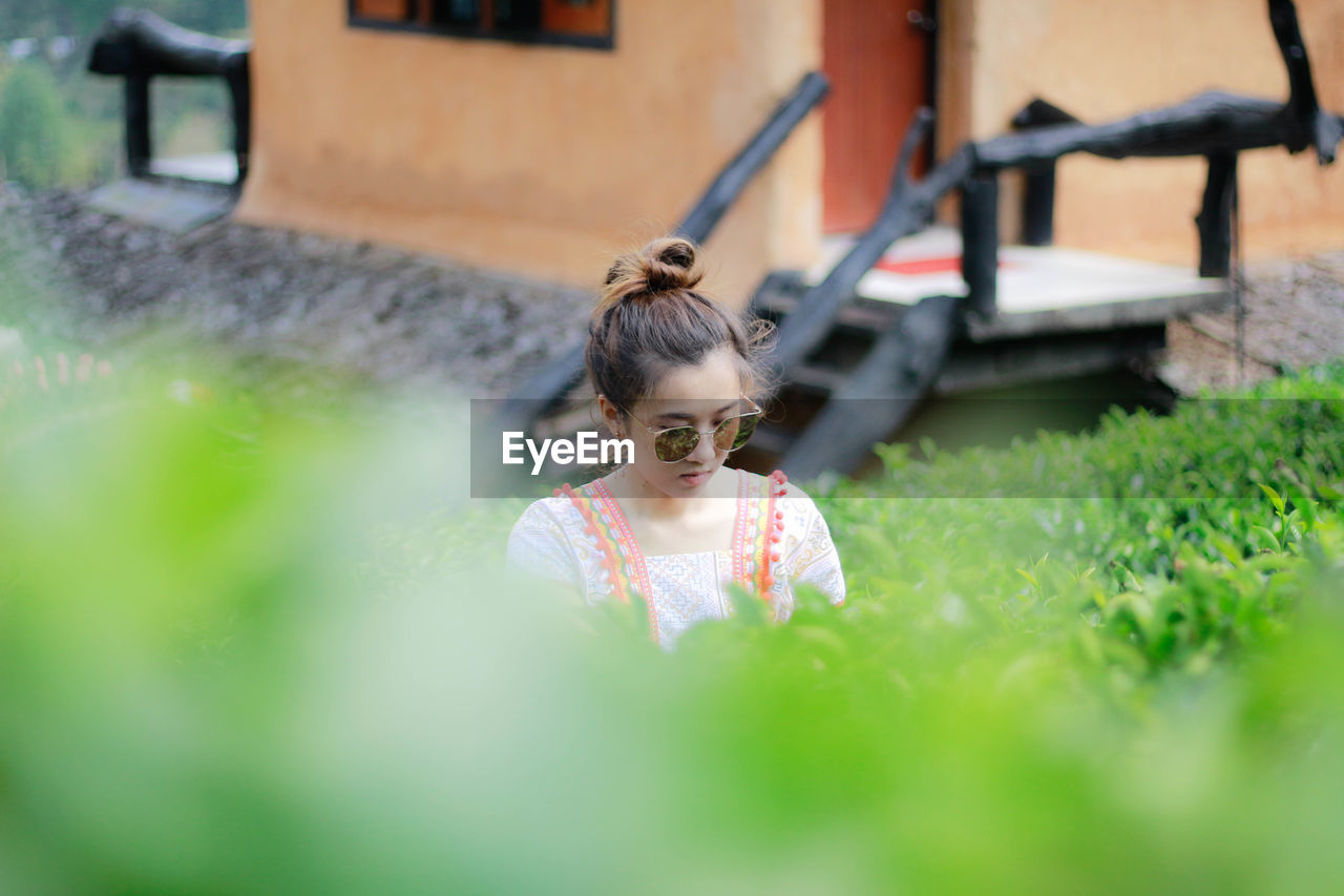 Young woman wearing sunglasses in public park