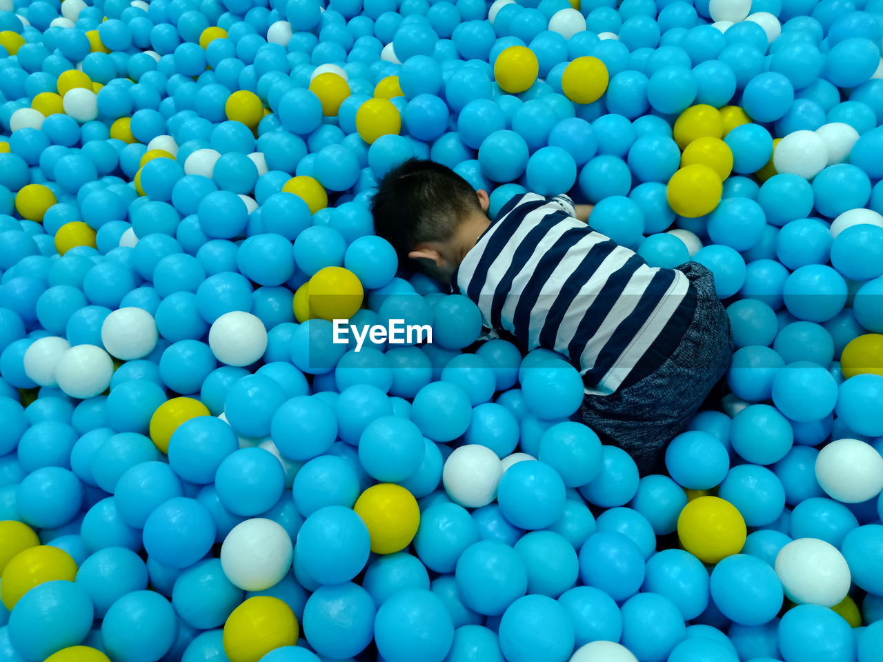 Rear view of boy at ball pool