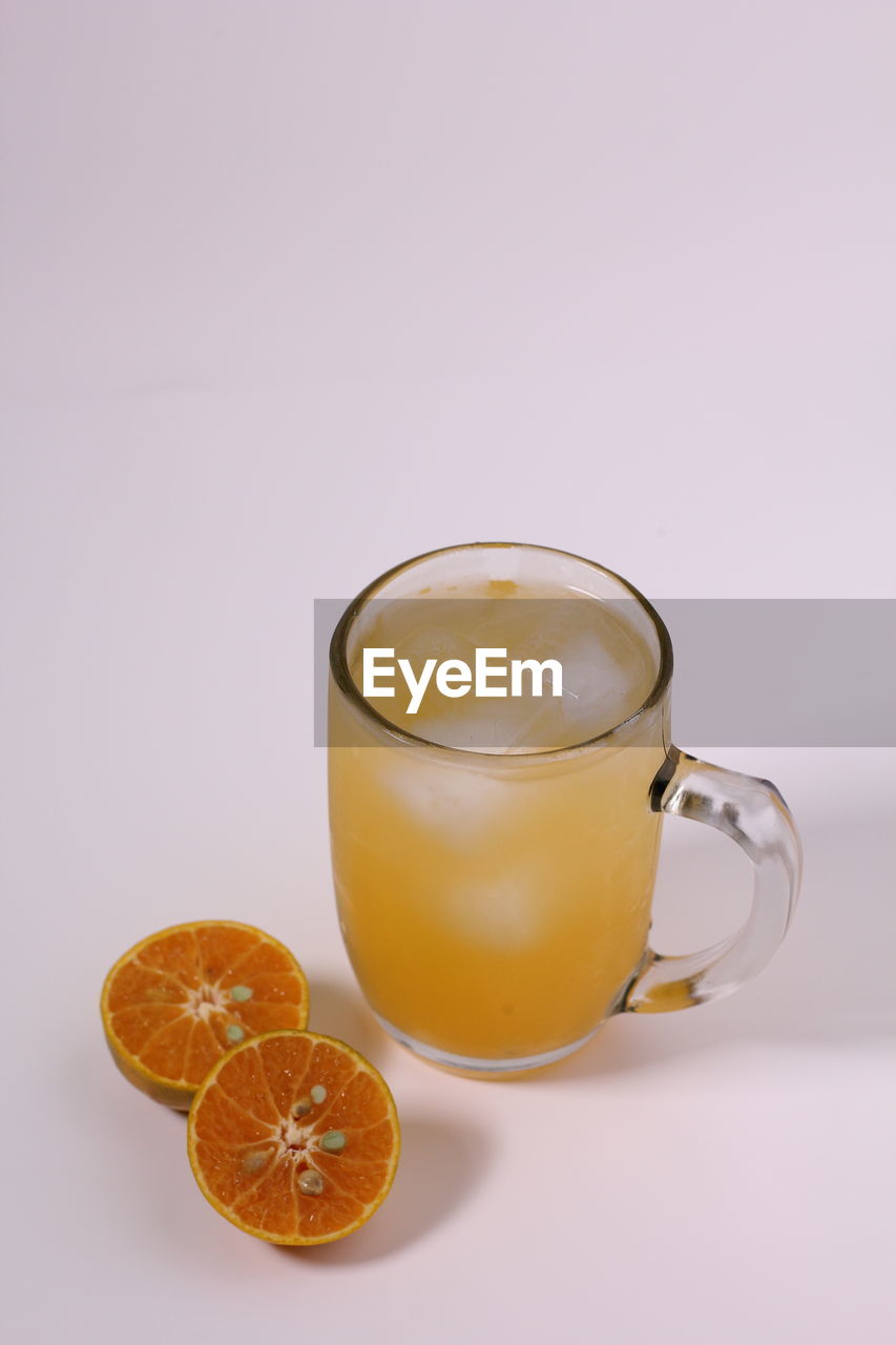 ORANGE JUICE AGAINST WHITE BACKGROUND
