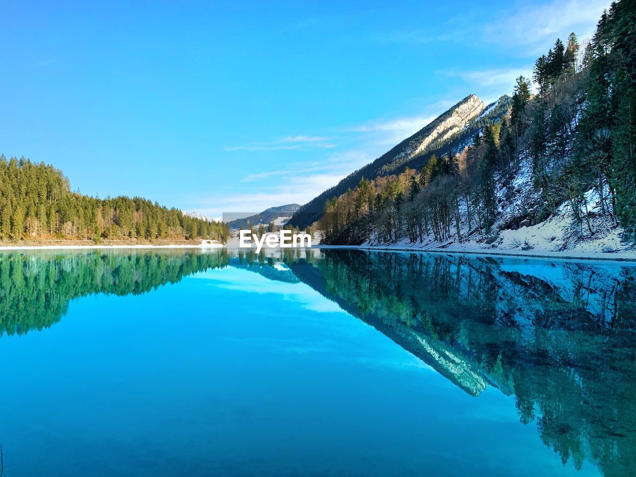 Scenic view of lake against blue sky