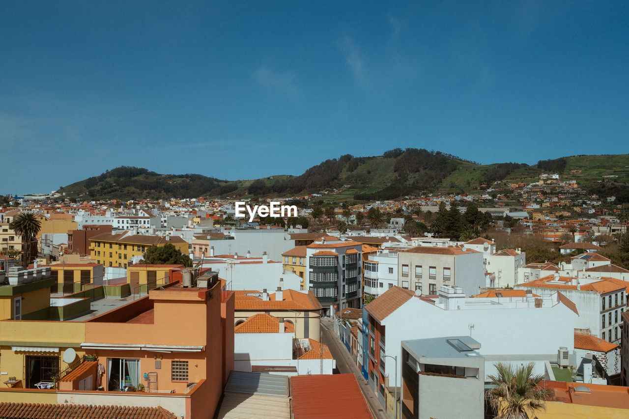 high angle view of buildings in city against sky