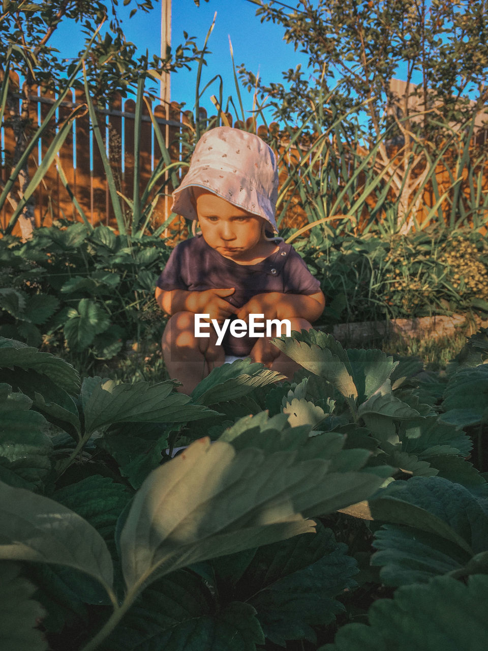 FULL LENGTH PORTRAIT OF BOY WITH PLANTS