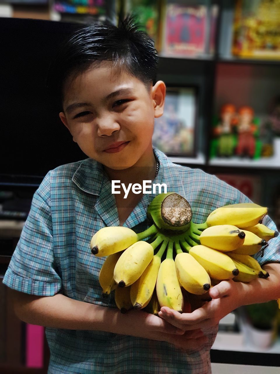 Portrait of boy holding bananas