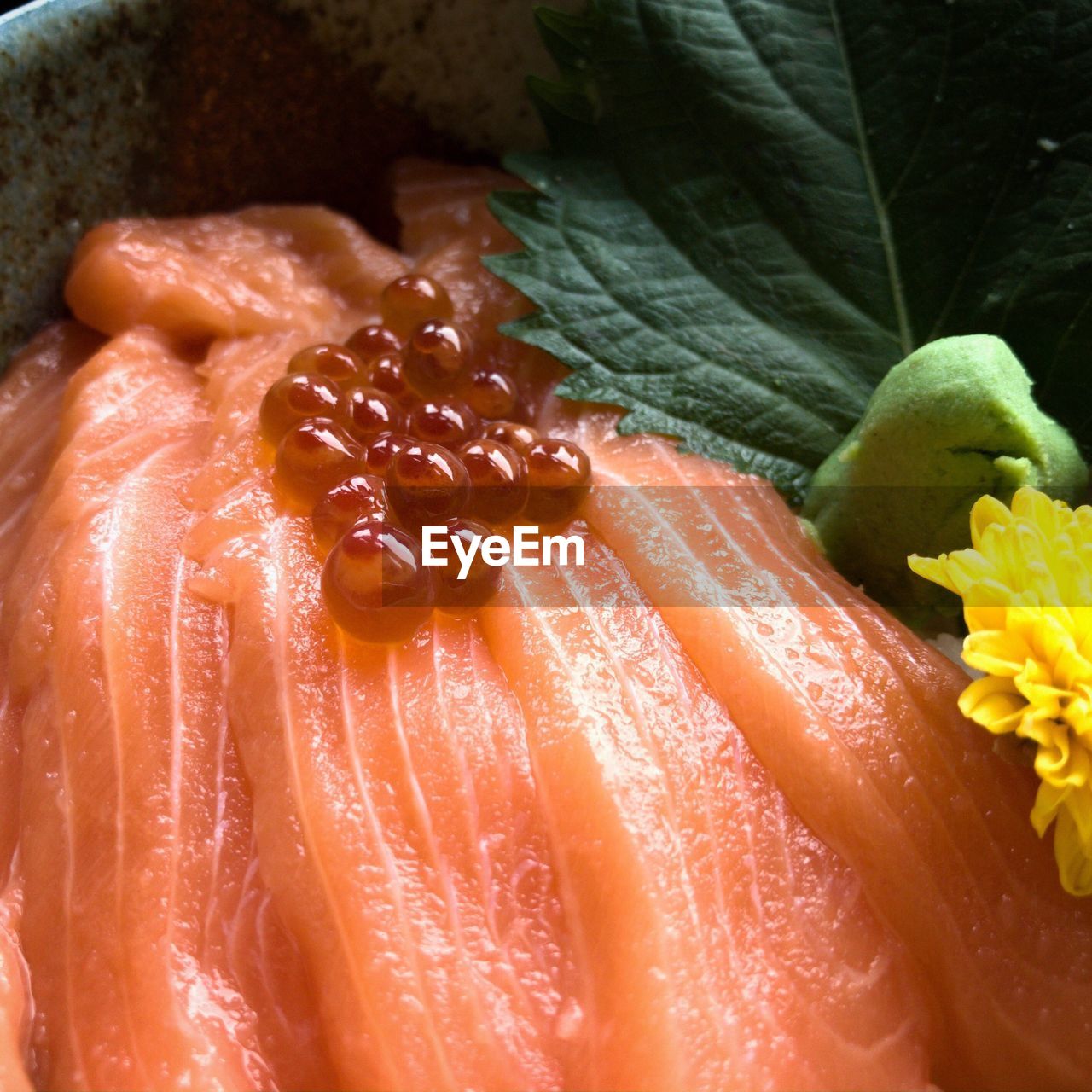 Close-up of caviar over salmon slice