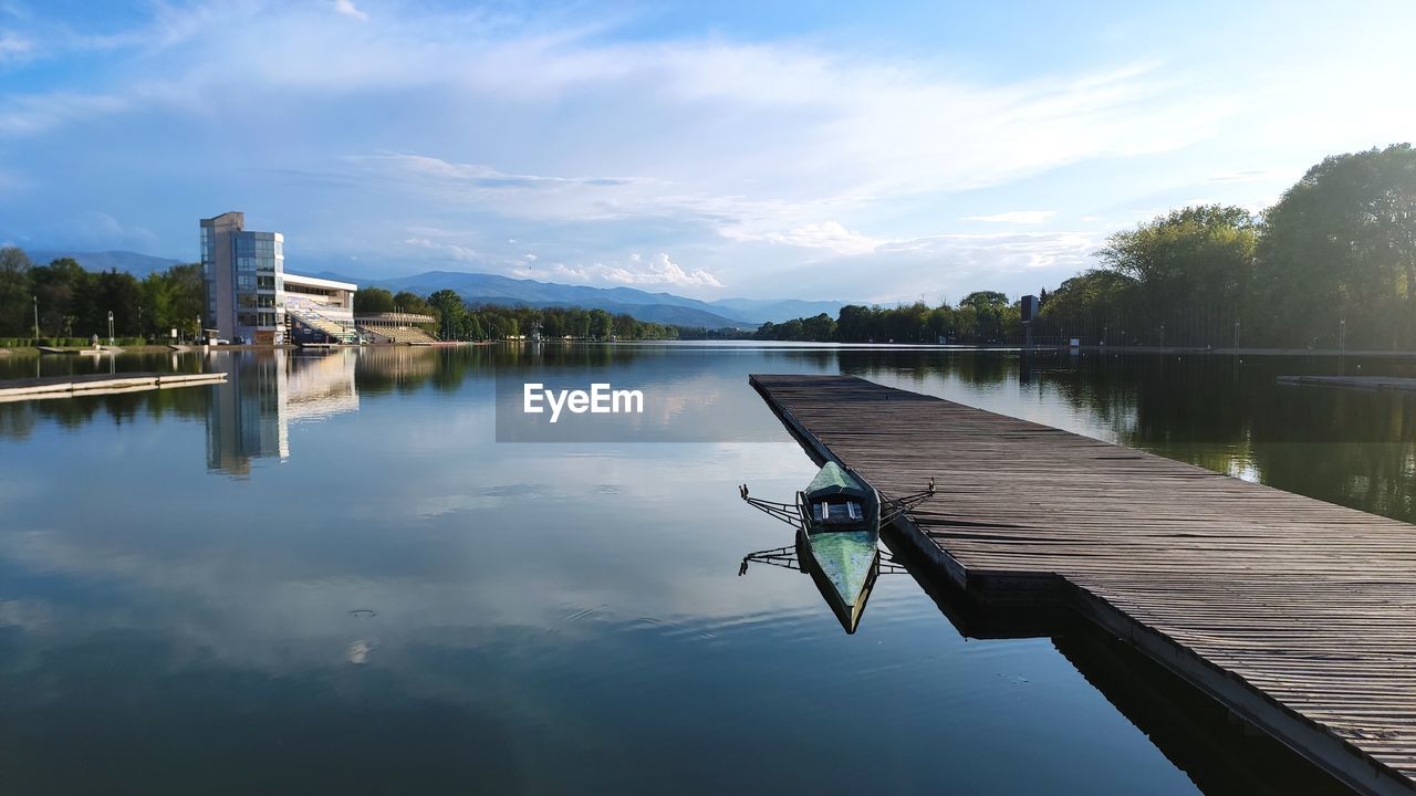 Pier on lake against sky