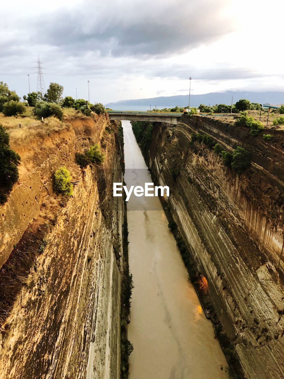 Panoramic shot of road by river against sky