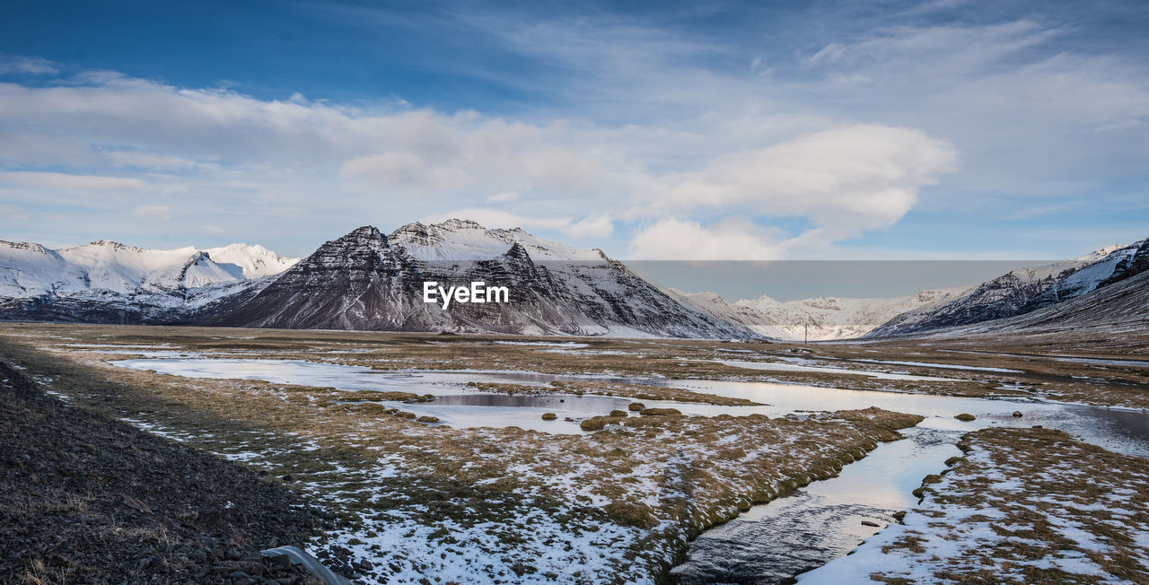 Scenic view of snowcapped mountains against sky. iceland.