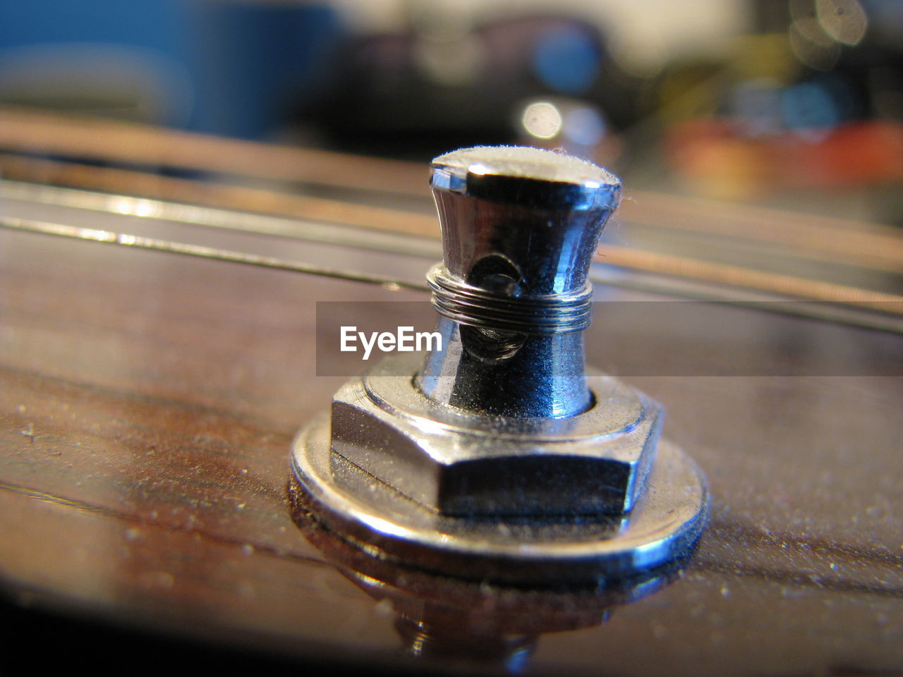 CLOSE-UP OF METAL CONTAINER ON TABLE WITH SPOON