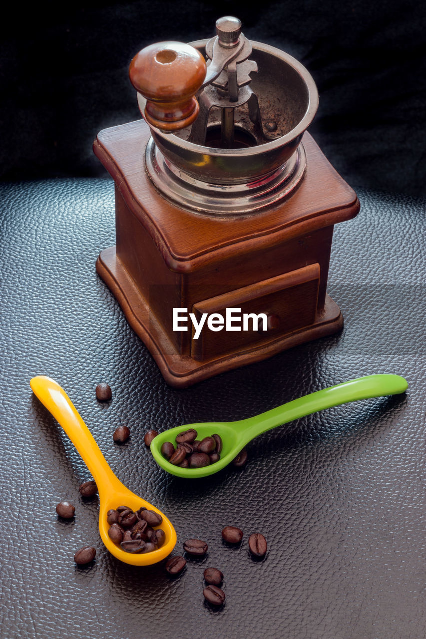 HIGH ANGLE VIEW OF OPEN BOOK ON TABLE AGAINST GRAY BACKGROUND