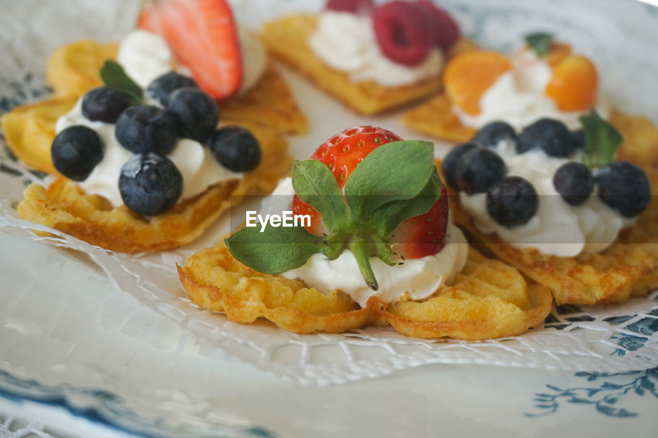 Close up of waffles with fresh berries and wipped cream