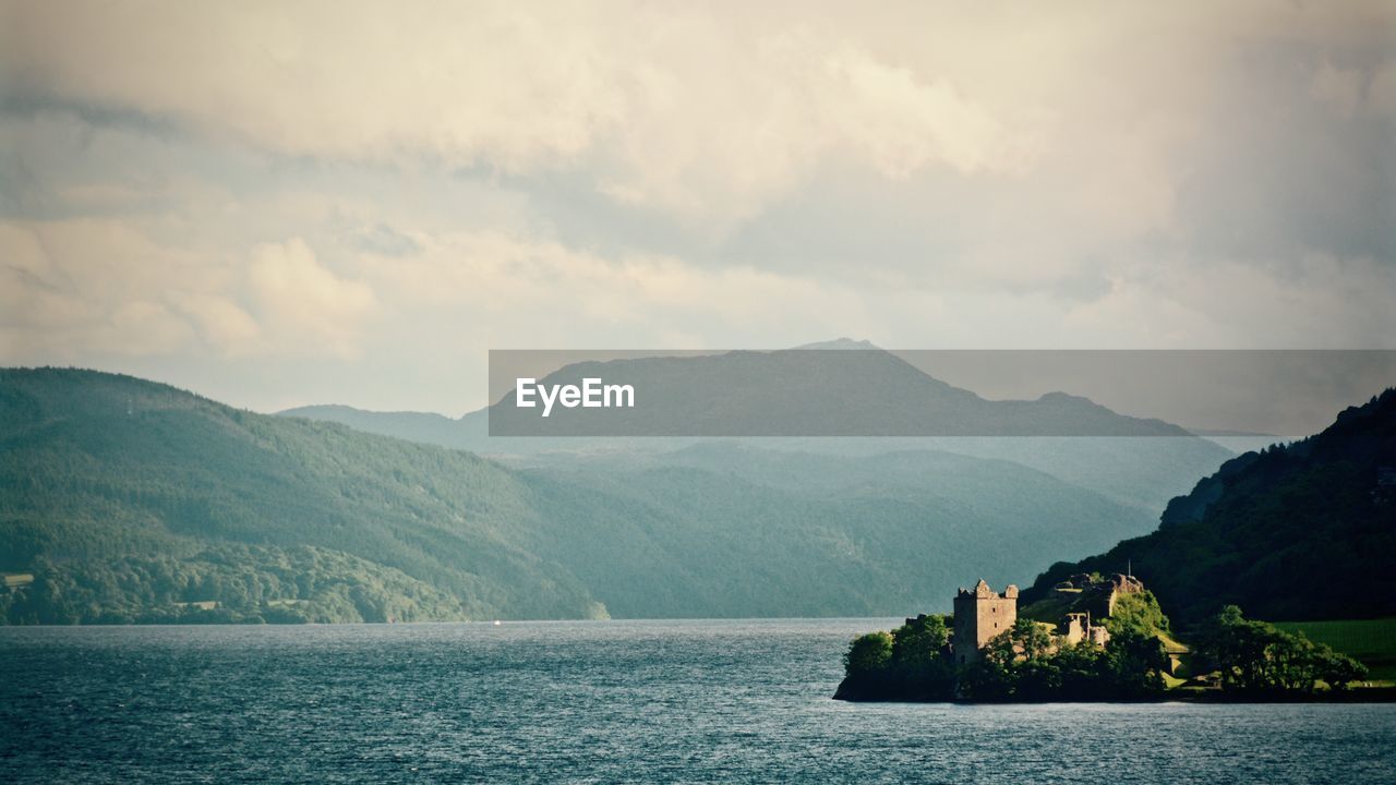 Scenic view of urquhart castle and loch ness with mountains against sky