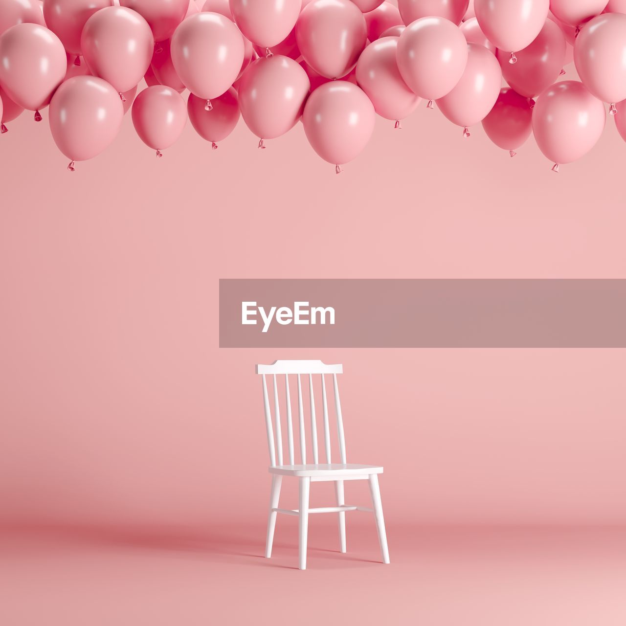 Balloons and chair against pink background