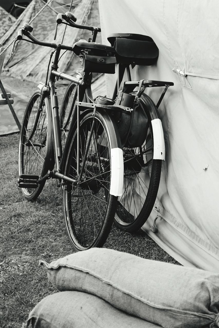 Bicycles parked on field by tents