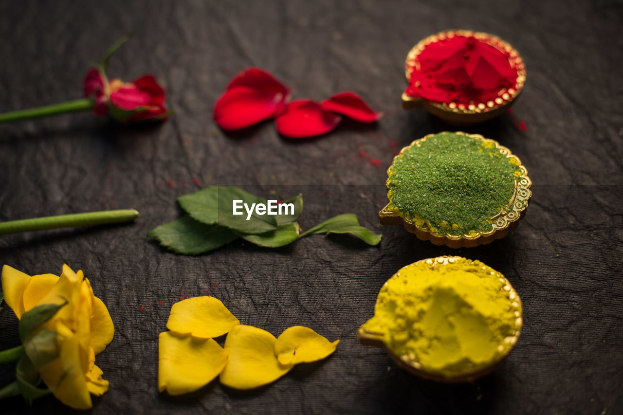 High angle view of flowers with powdered paint on table